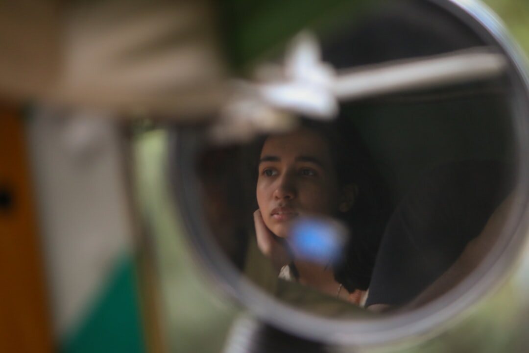 person looking in mirror reflection