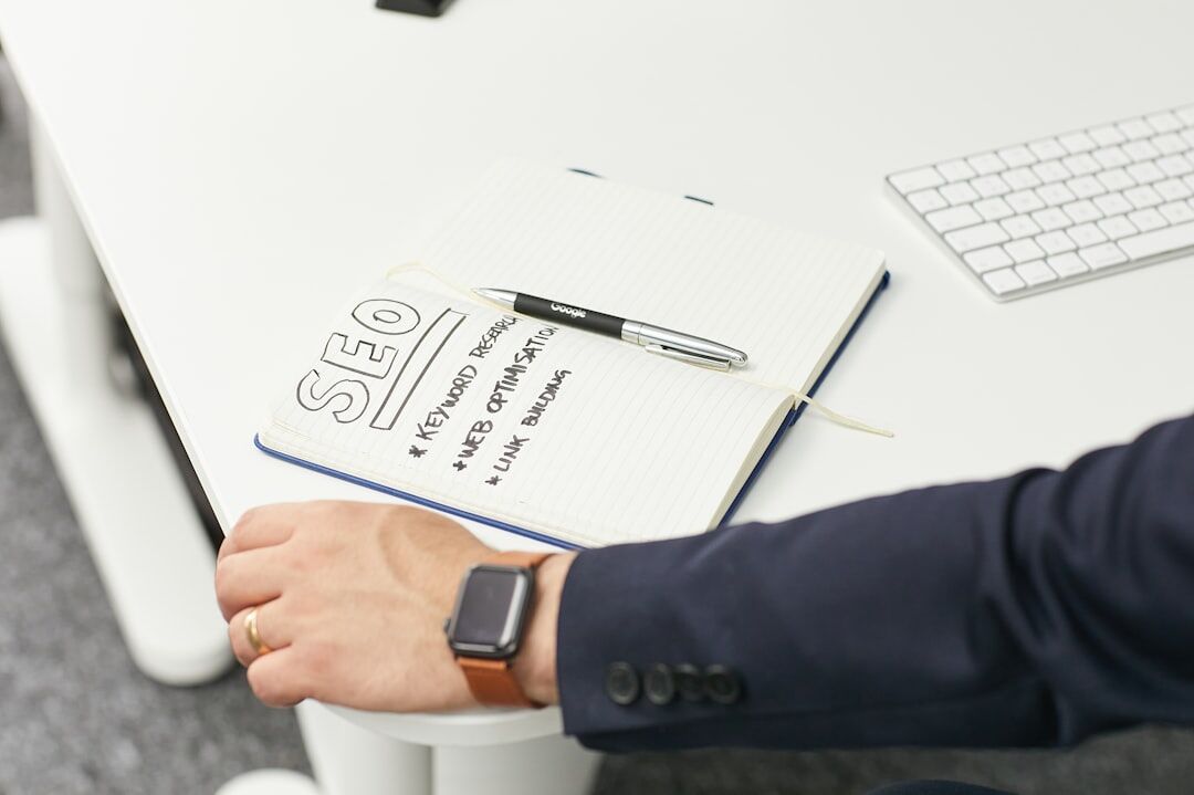 person writing in journal notebook