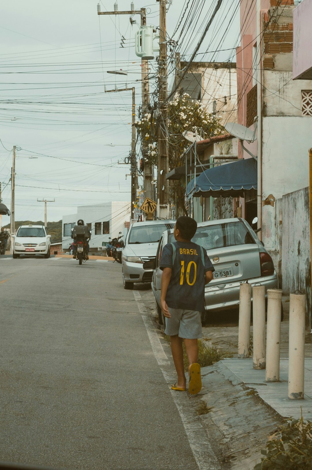 Young Brazilian man walking confidently on an urban street