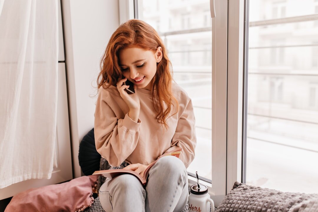 Brazilian woman smiling during a phone call in an office