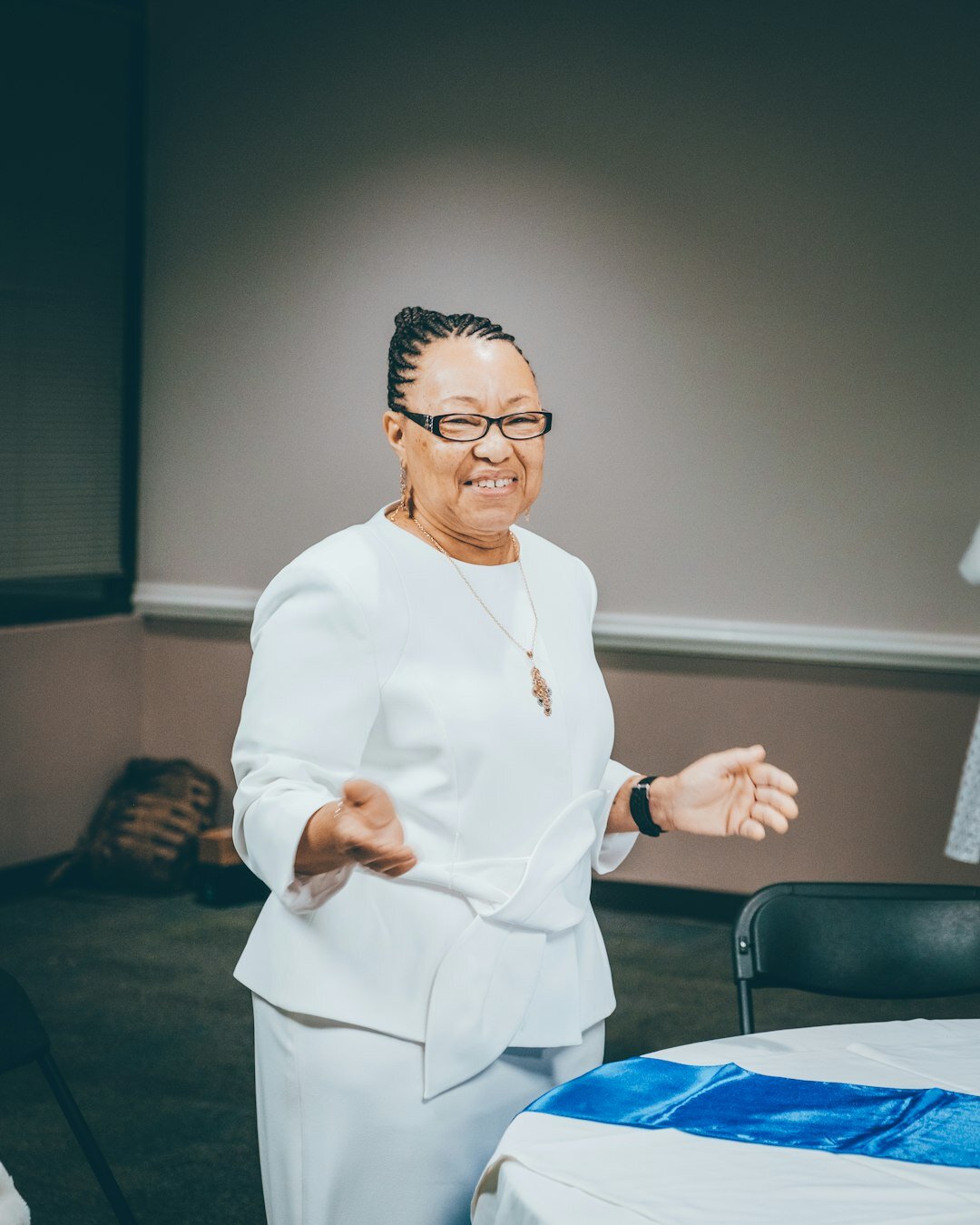Woman speaking confidently to a small group in a presentation setting