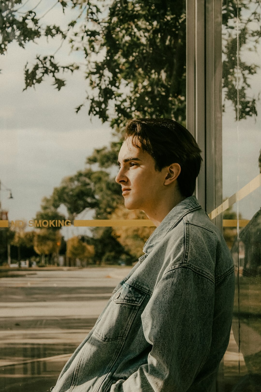 Person reflecting alone while looking out a window