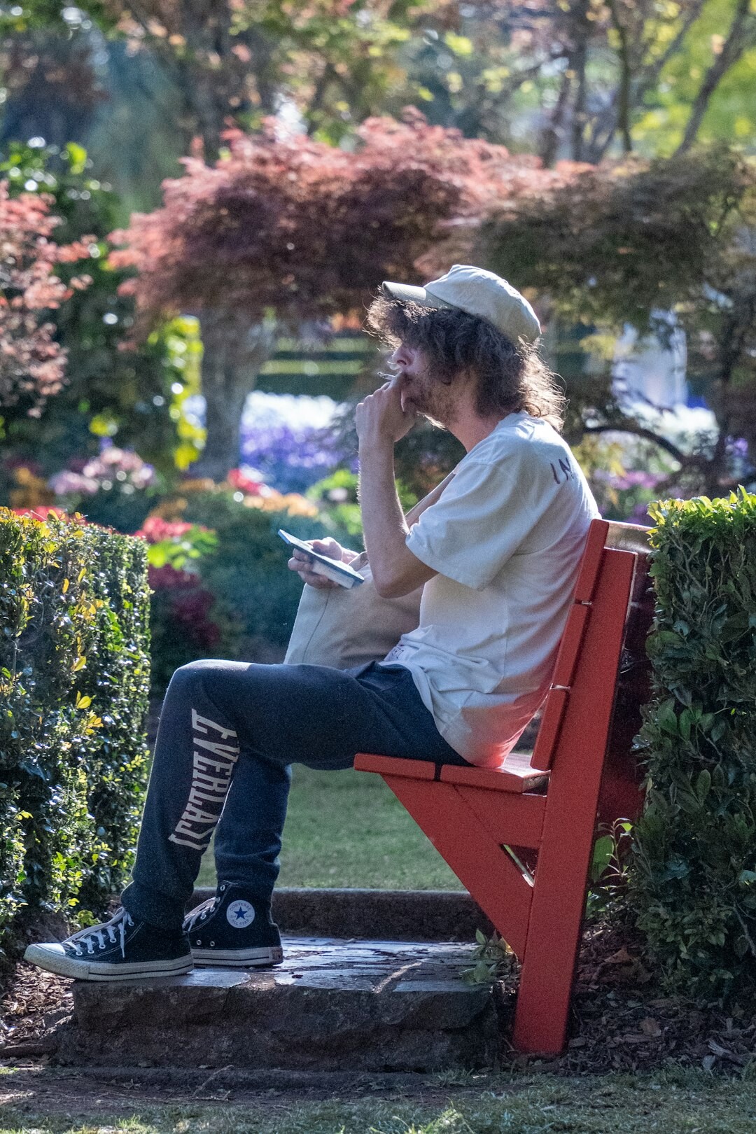 Person journaling outdoors on a park bench